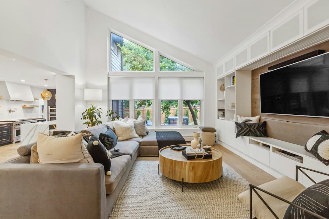 A large TV in a bright modern living room, illustrating 4K streaming with Moly IPTV